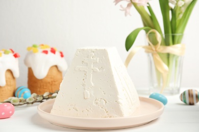 Traditional cottage cheese Easter paskha on white wooden table