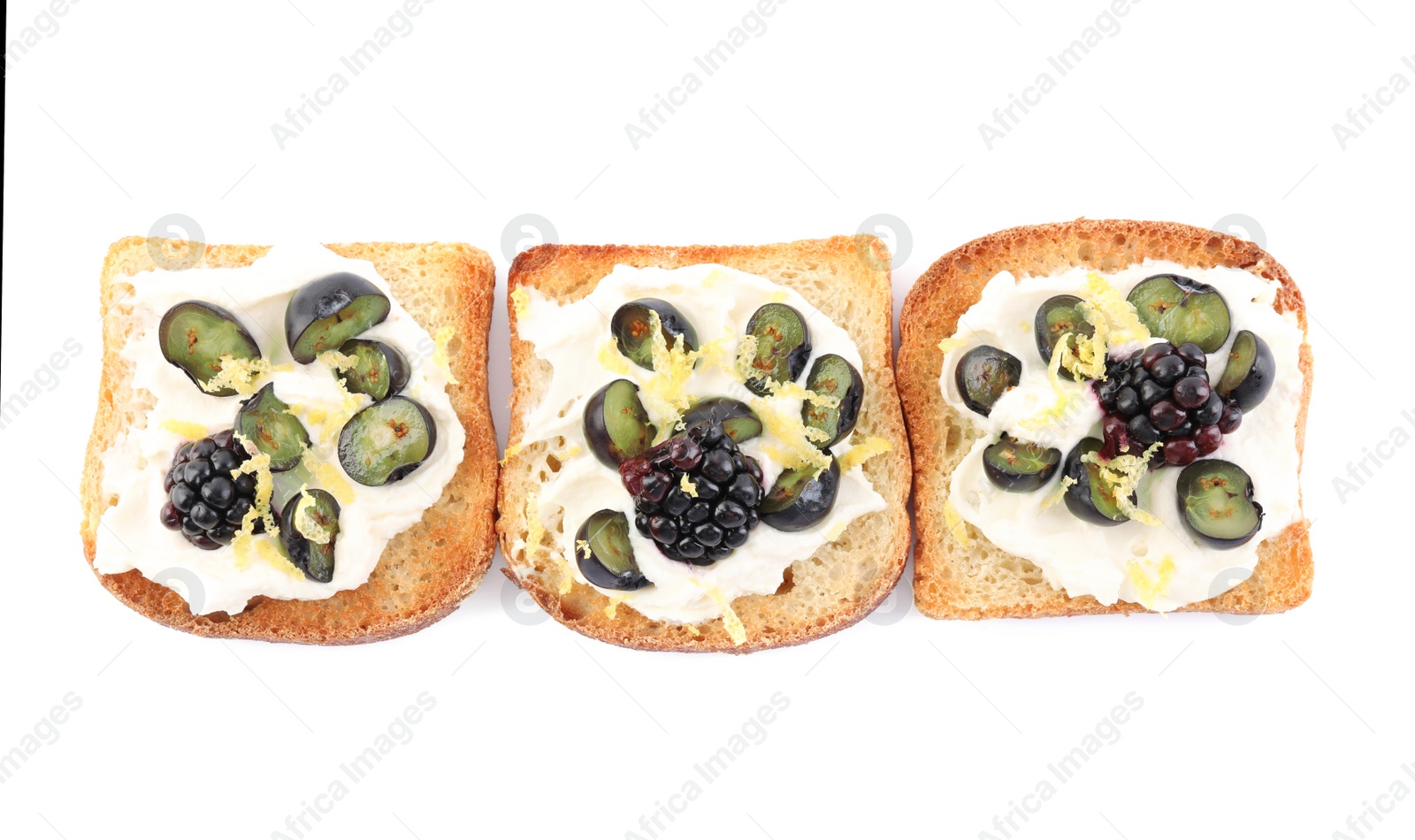 Photo of Tasty sandwiches with cream cheese, blueberries, blackberries and lemon zest on white background, top view