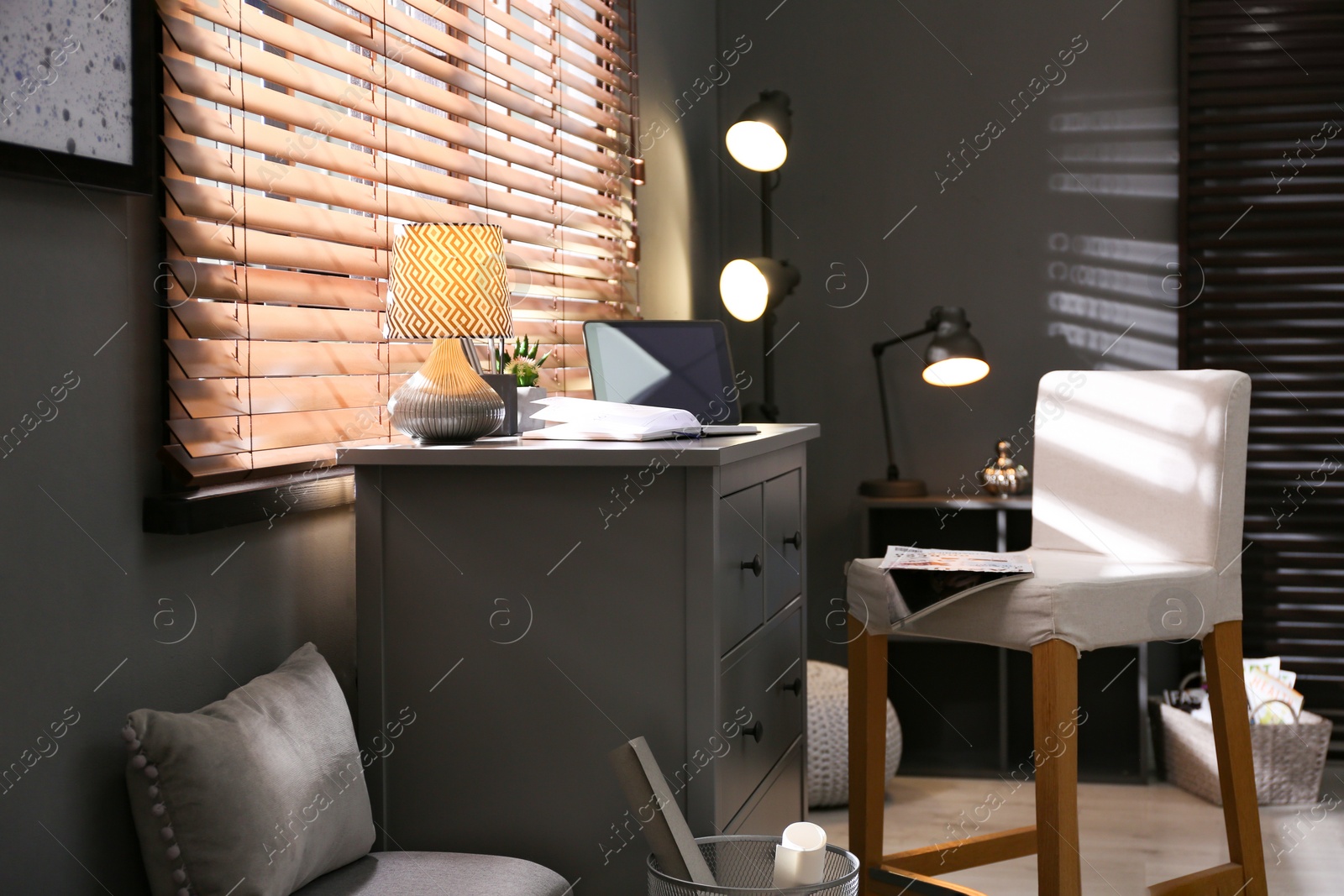 Photo of Stylish room interior with comfortable workplace near window