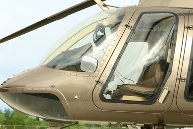 New modern helicopter with leather seats in field