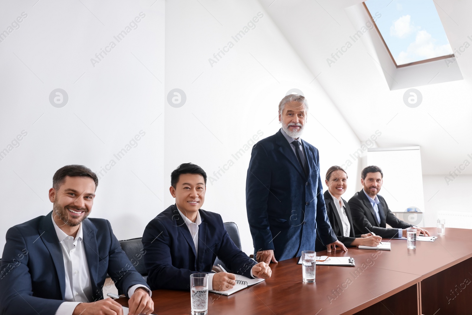 Photo of Business conference. People in meeting room listening to speaker report