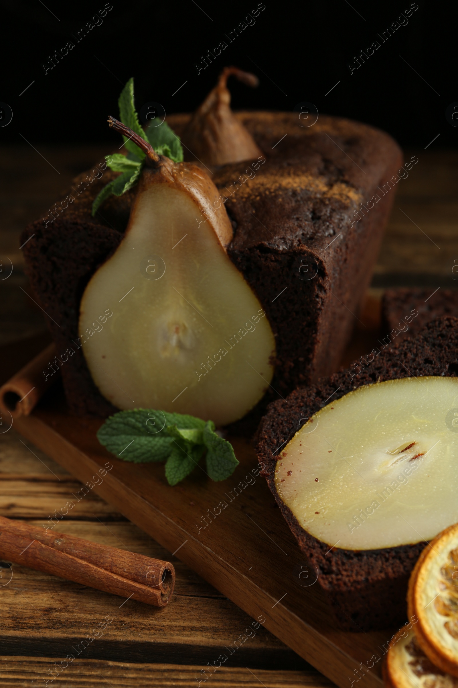 Photo of Tasty pear bread with mint and cinnamon on wooden table. Homemade cake