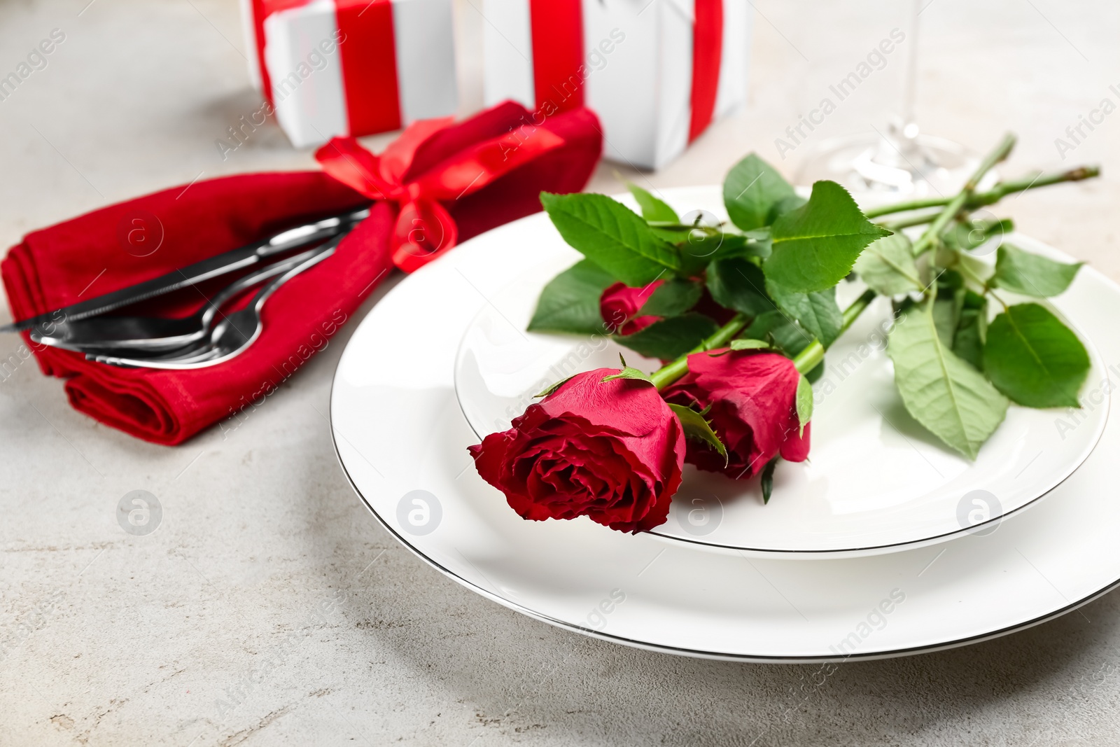 Photo of Beautiful table setting for Valentine's Day dinner with roses on white background, closeup