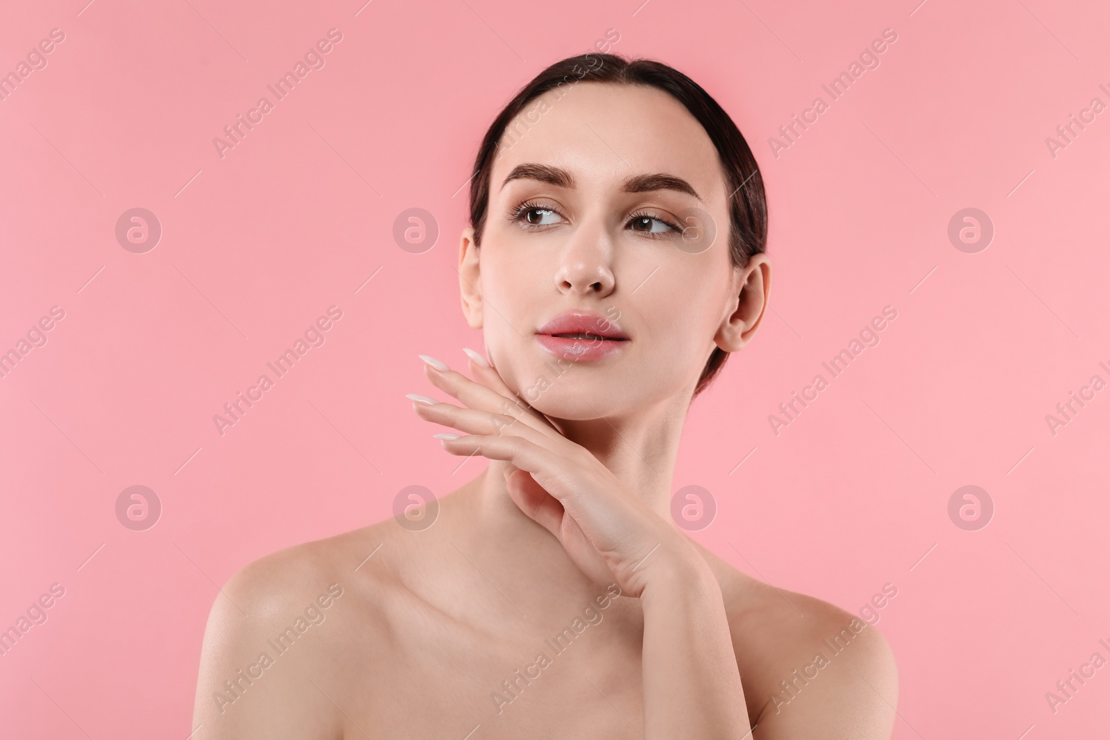 Photo of Portrait of beautiful young woman on pink background