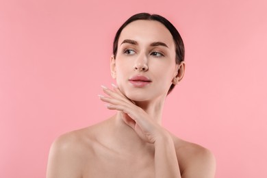 Portrait of beautiful young woman on pink background