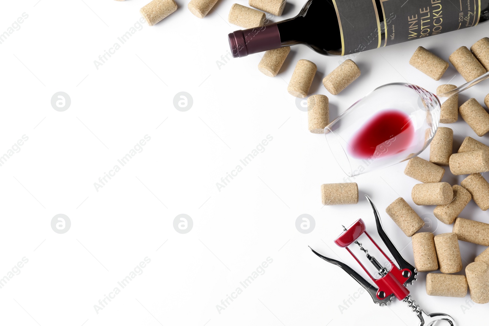 Photo of Corkscrew with wine bottle, glass and stoppers on white background, top view