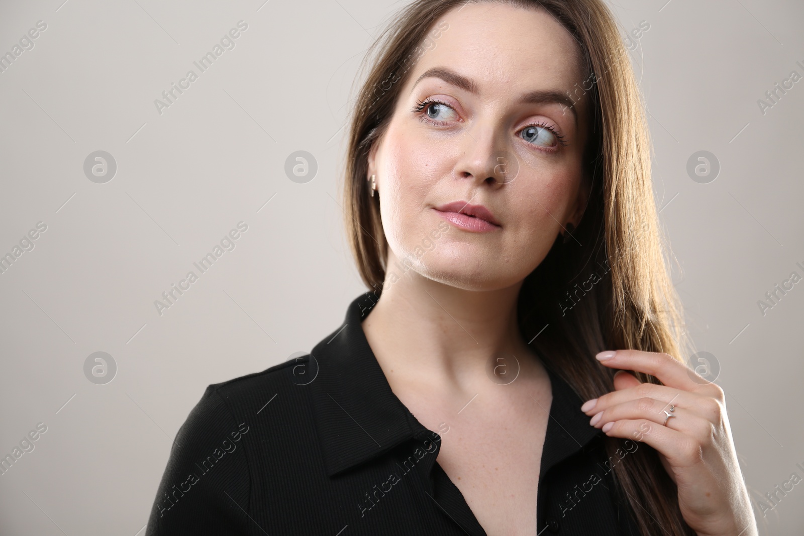 Photo of Portrait of beautiful young woman on beige background