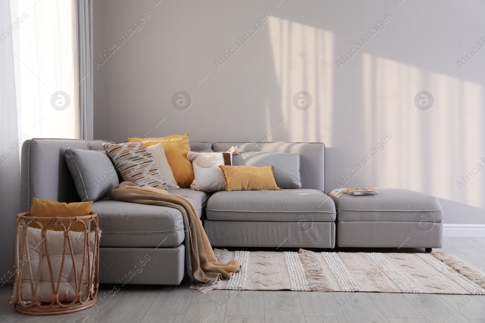 Photo of Living room interior with large grey sofa