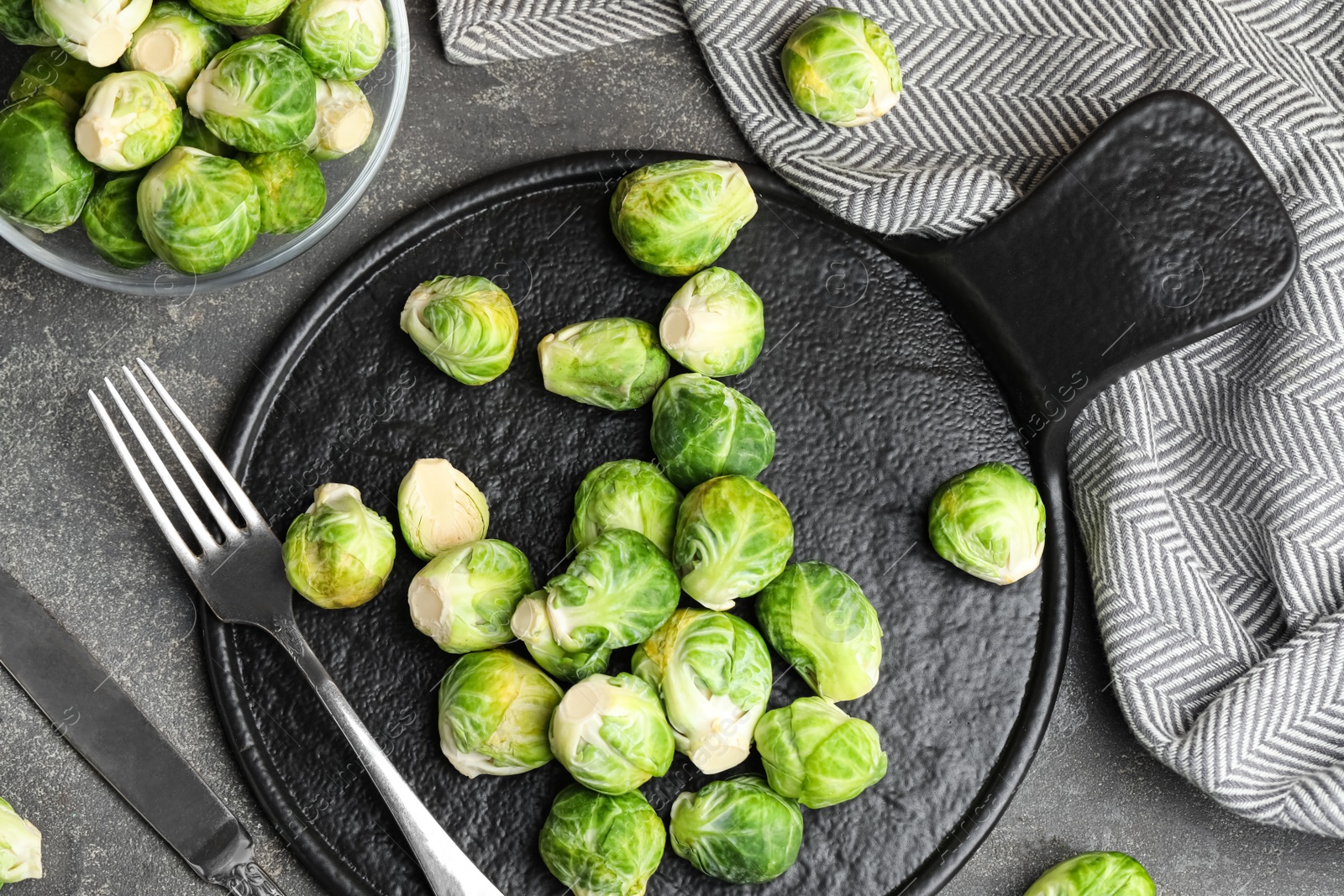 Photo of Fresh Brussels sprouts on grey table, flat lay