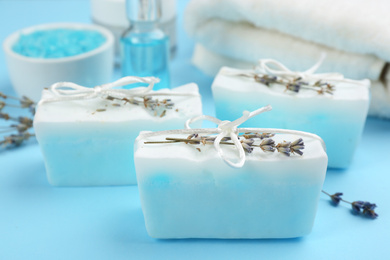 Photo of Natural handmade soap bars on light blue background, closeup