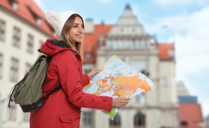 Happy traveler with map in foreign city. Vacation trip