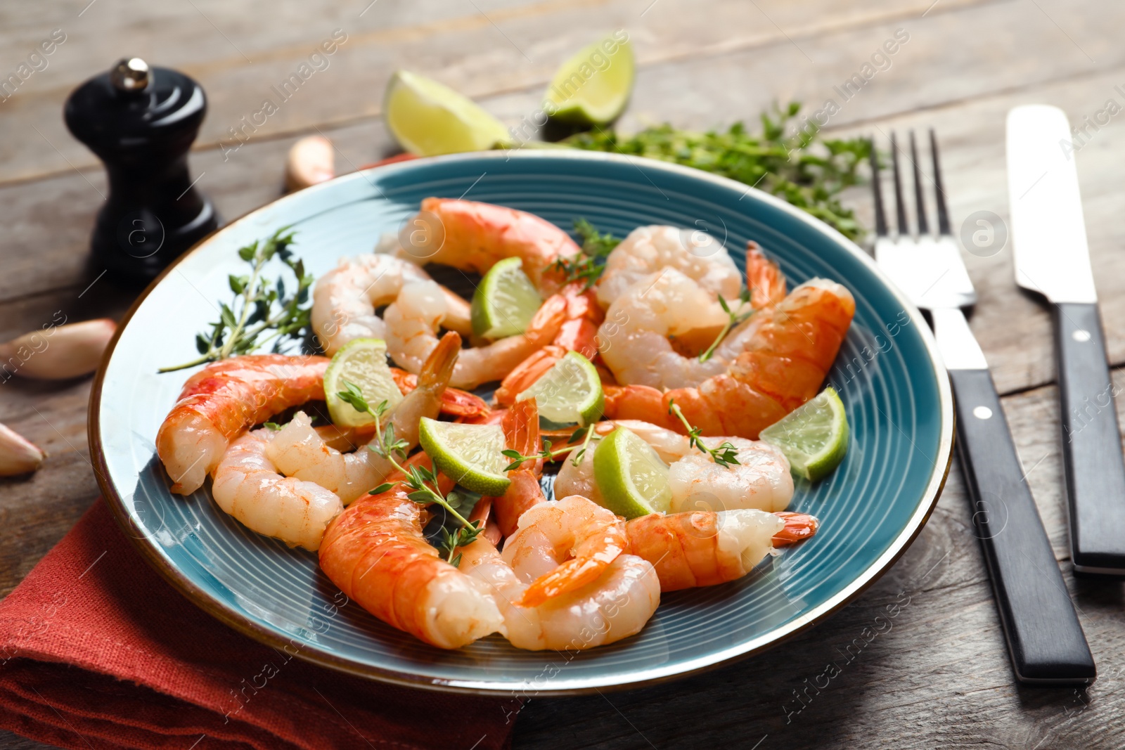 Photo of Plate with delicious shrimps on wooden table