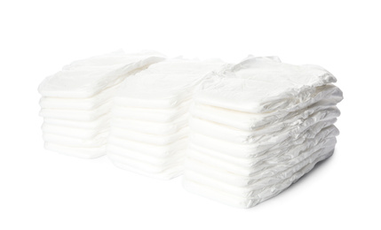 Photo of Stacks of baby diapers isolated on white