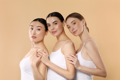 Photo of Beautiful young women with healthy skin on beige background