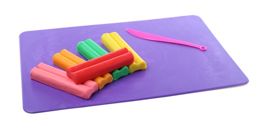 Many different colorful plasticine pieces and sculpting knife on white background