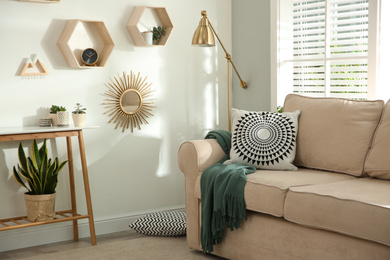 Photo of Stylish beige sofa in modern living room interior
