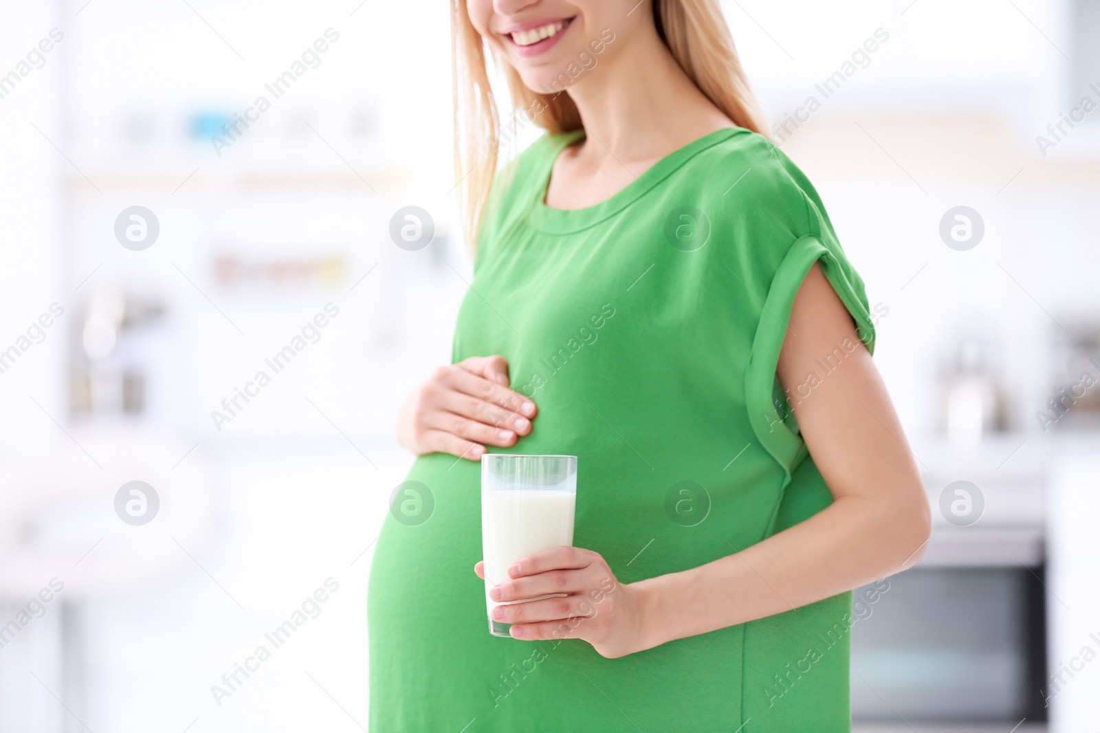 Photo of Beautiful pregnant woman drinking milk at home