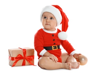 Photo of Festively dressed little baby with Christmas gift on white background