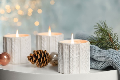 Composition with candles in ornate holders on table. Christmas decoration