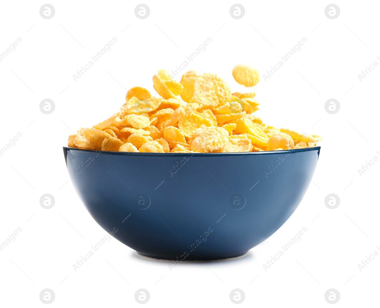 Photo of Crispy cornflakes falling into bowl on white background