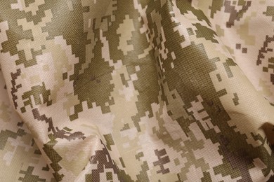 Texture of crumpled camouflage fabric as background, closeup