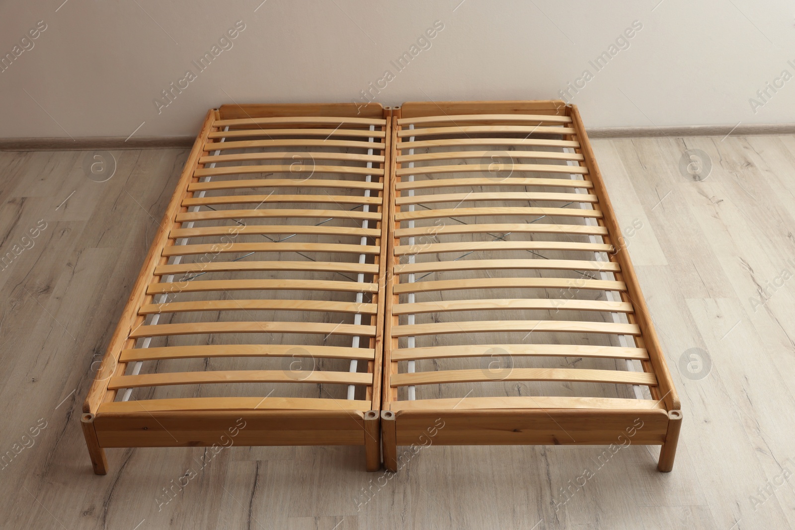 Photo of Wooden bed frame on floor in room