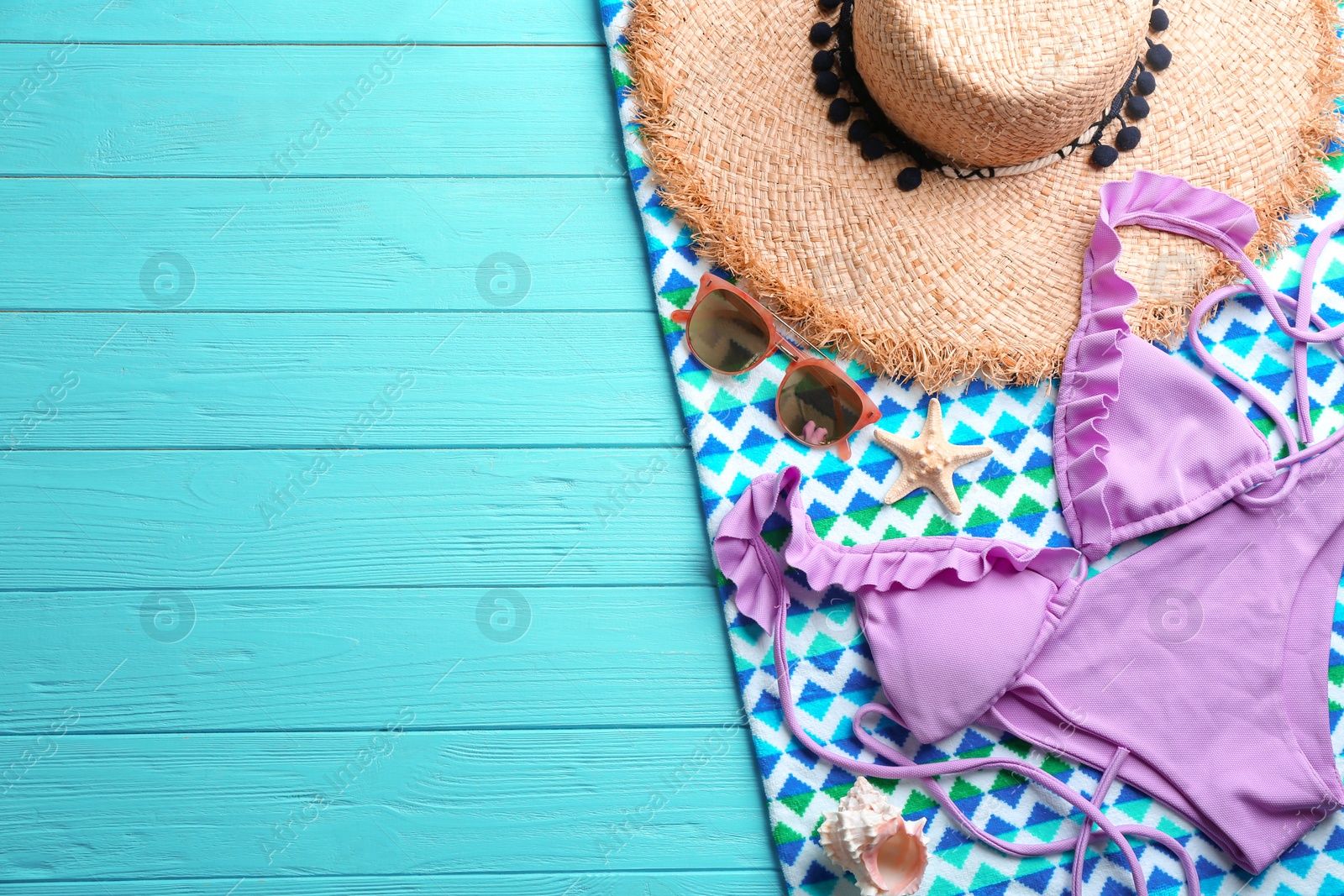 Photo of Flat lay composition with beach accessories on color wooden background. Space for text