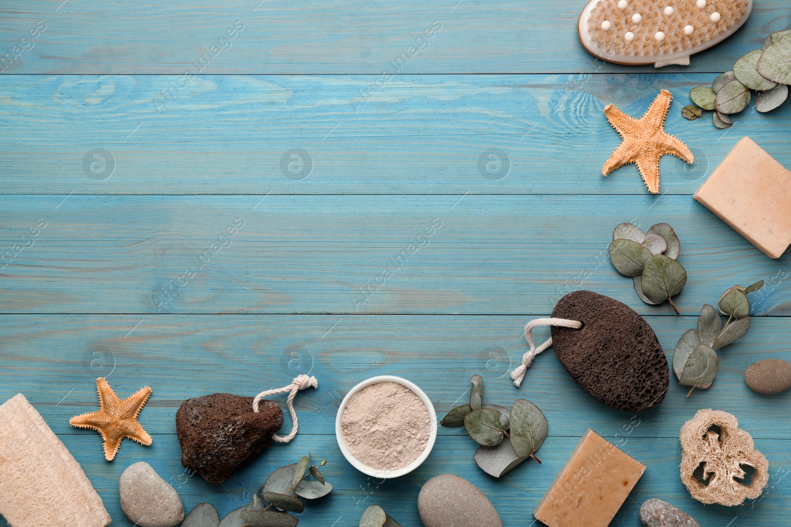 Photo of Flat lay composition with pumice stones on turquoise wooden background. Space for text