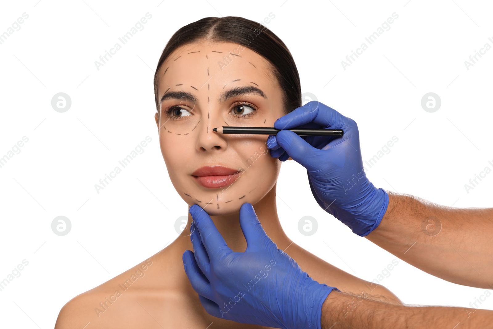 Photo of Doctor with pencil preparing patient for cosmetic surgery operation on white background