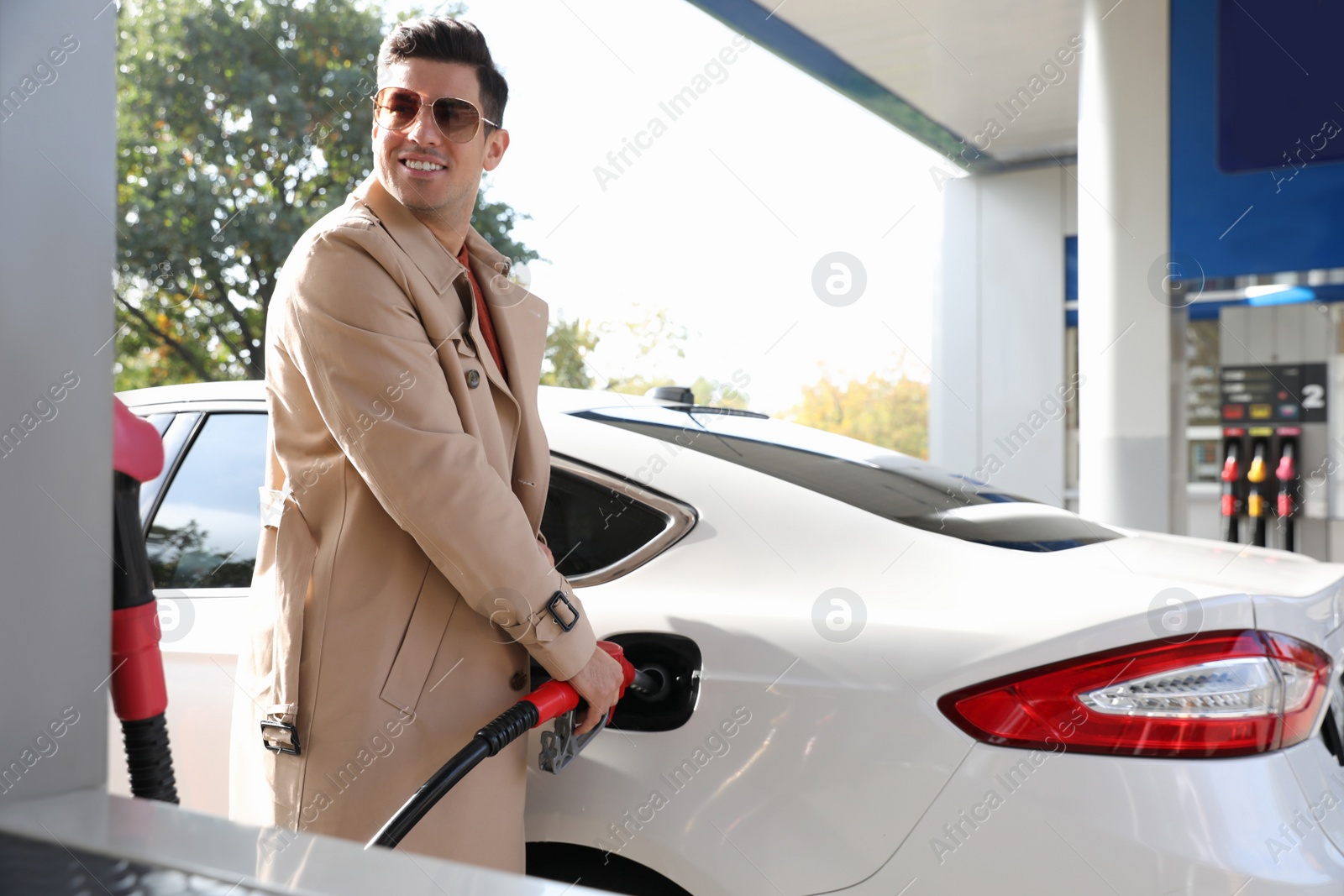 Photo of Man refueling car at self service gas station