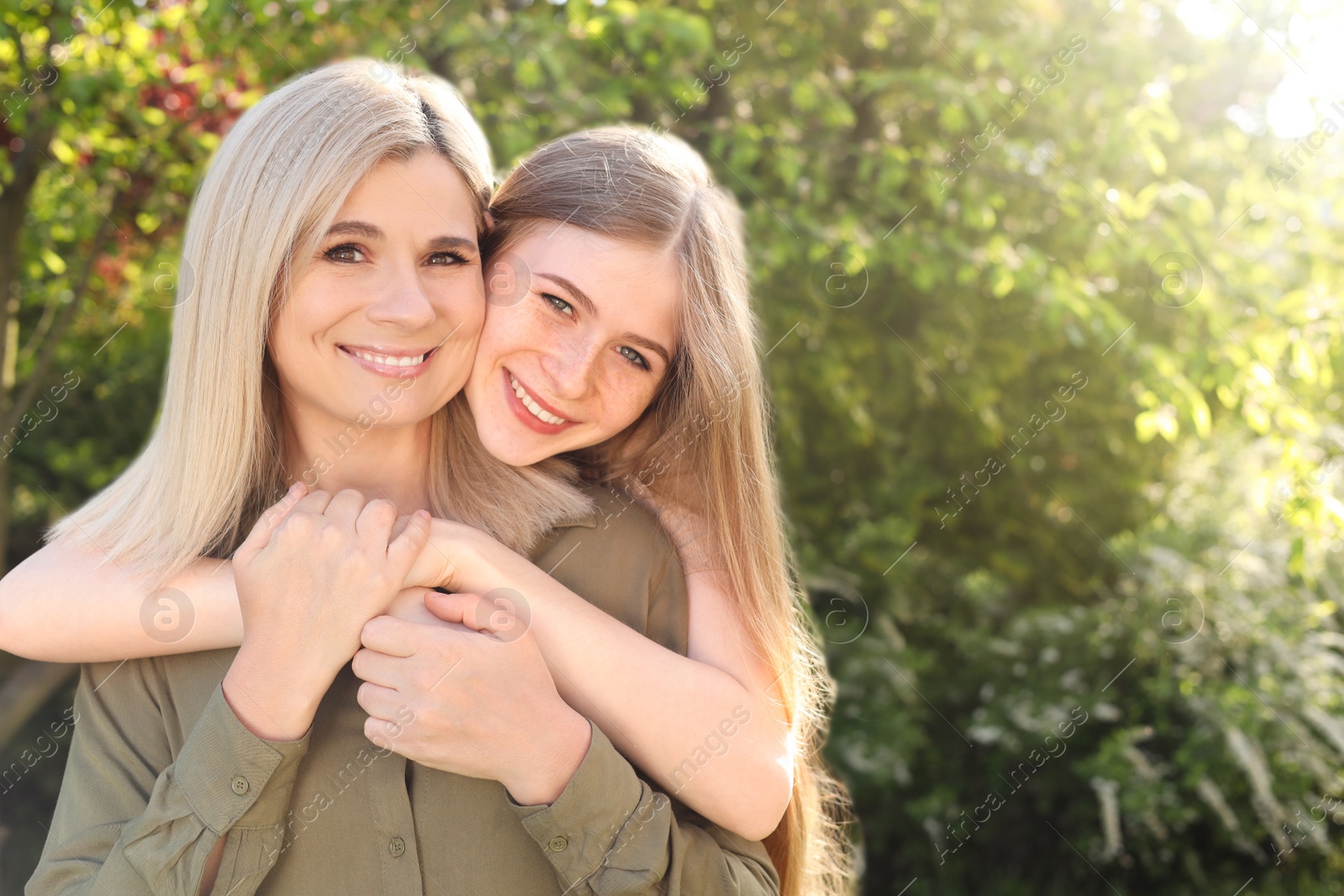 Photo of Happy mother with her daughter spending time together in park on sunny day