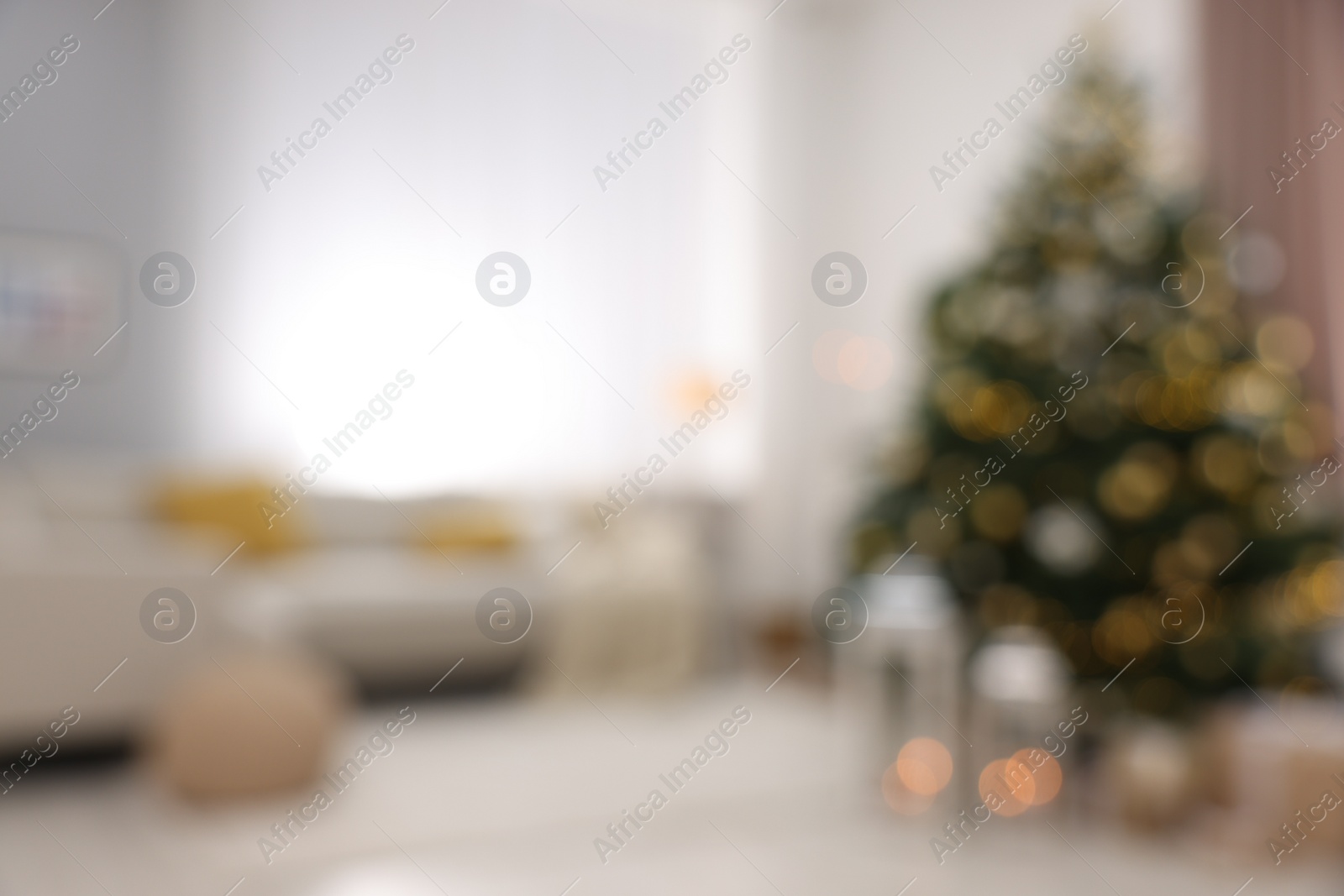 Photo of Christmas tree in furnished living room, blurred view. Festive interior design