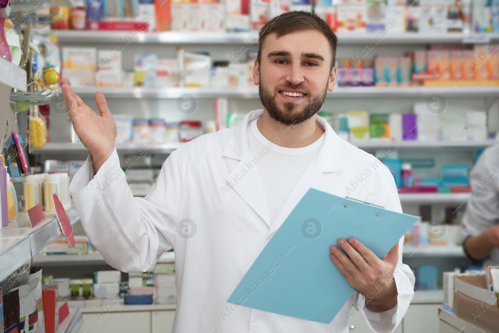 Photo of Professional pharmacist with clipboard in modern drugstore