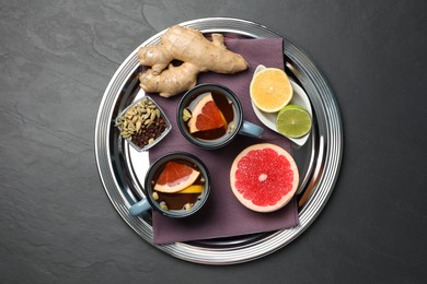 Photo of Immunity boosting drink and ingredients on black table, top view