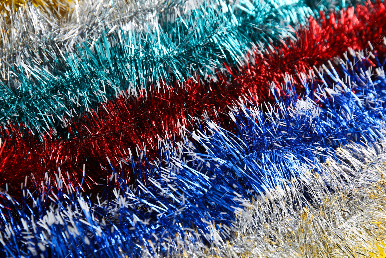 Photo of Many colorful tinsels as background, closeup view