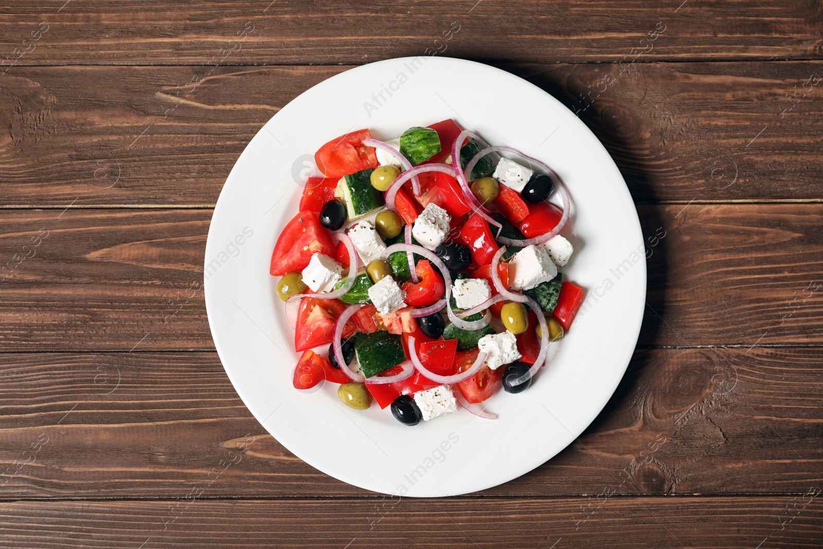 Photo of Plate with delicious salad on table, top view