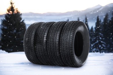 Image of Set of new winter tires outdoors on snow