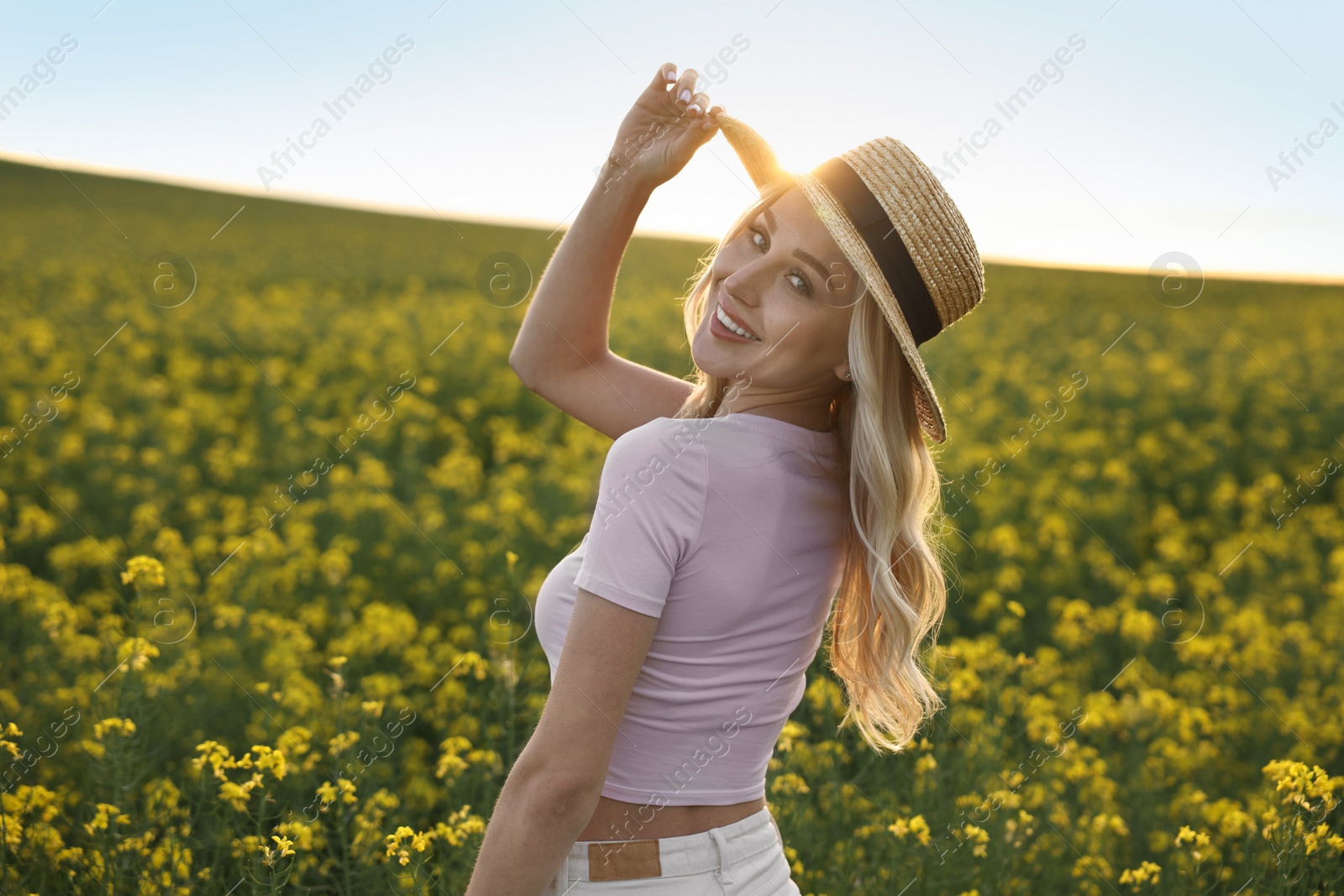 Photo of Portrait of happy young woman in field on spring day