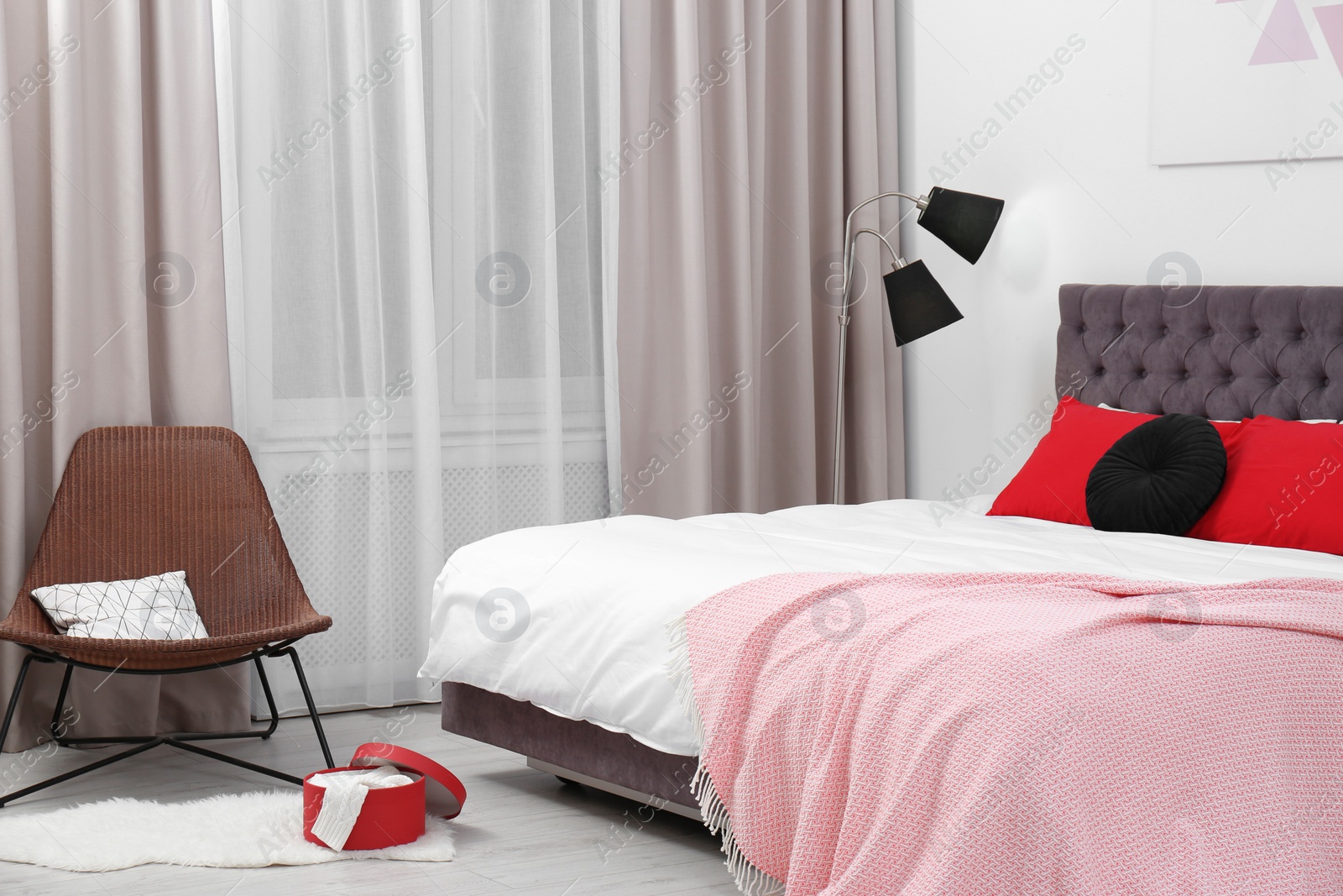 Photo of Stylish room interior with large comfortable bed