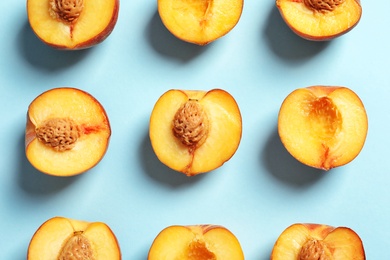 Photo of Flat lay composition with ripe peaches on color background