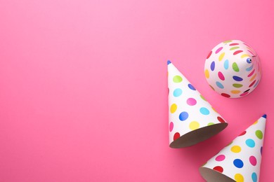 Photo of Beautiful party hats on pink background, top view. Space for text