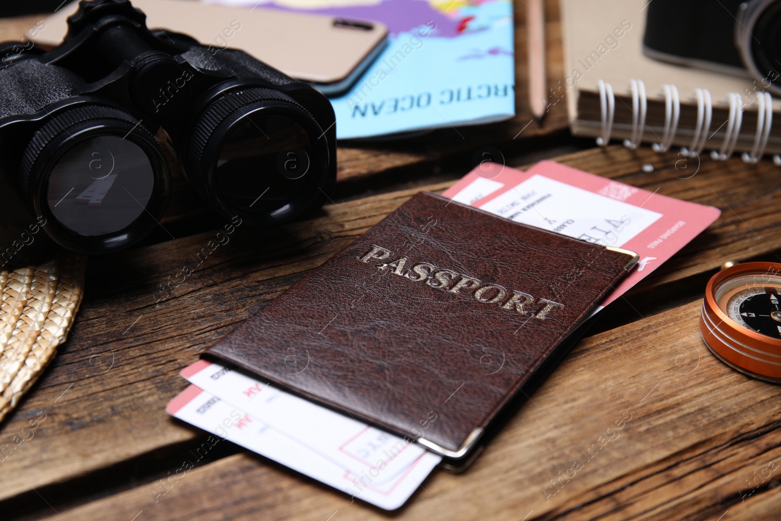 Photo of Composition with passport and tickets on wooden table, closeup