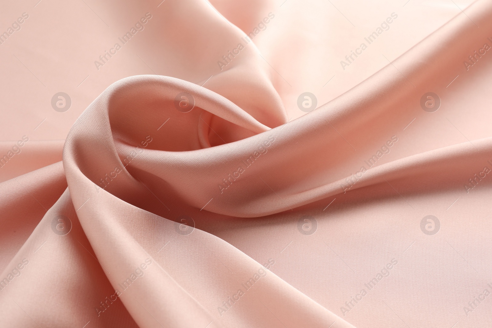 Photo of Crumpled pink silk fabric as background, closeup