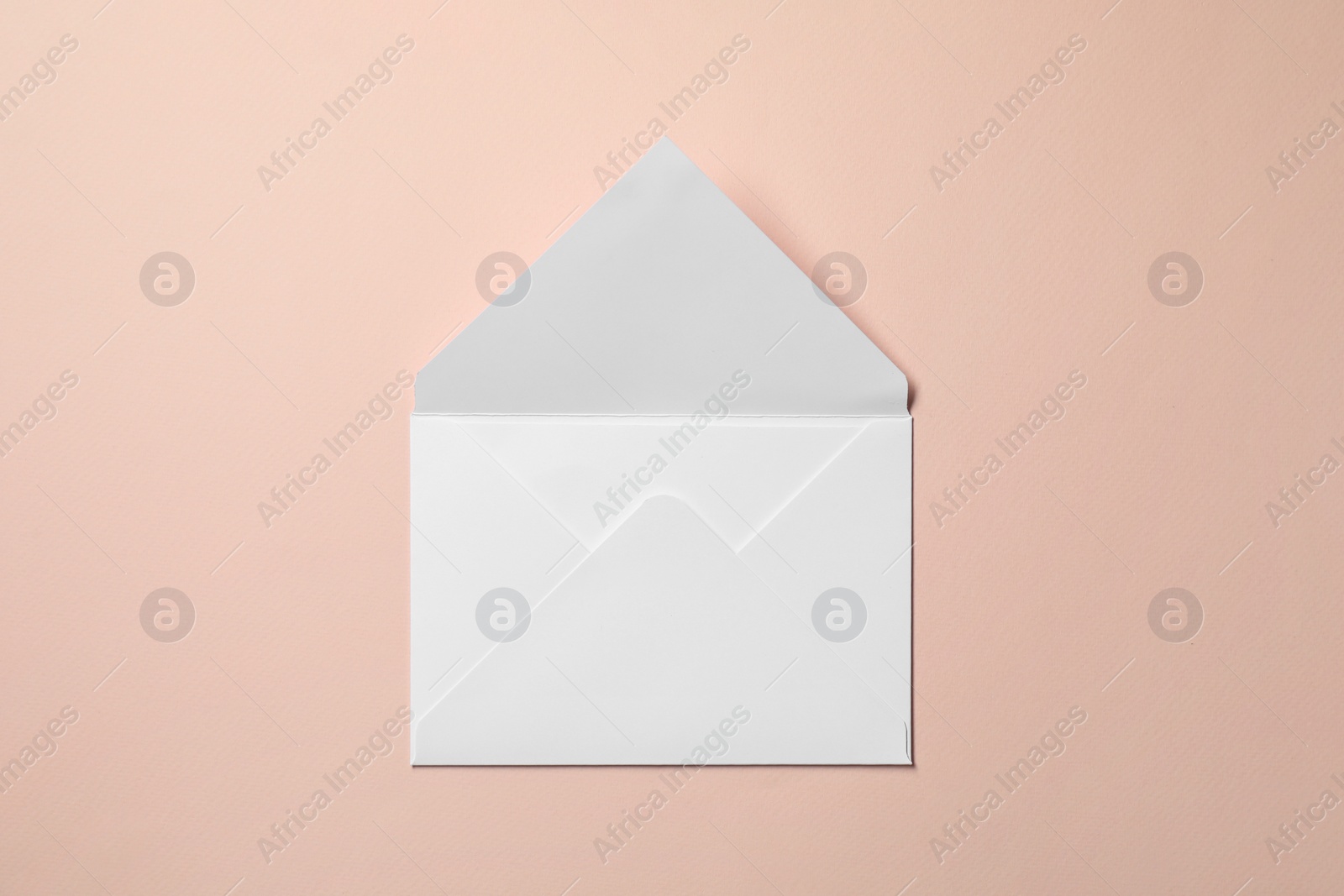 Photo of Letter envelope on beige background, top view