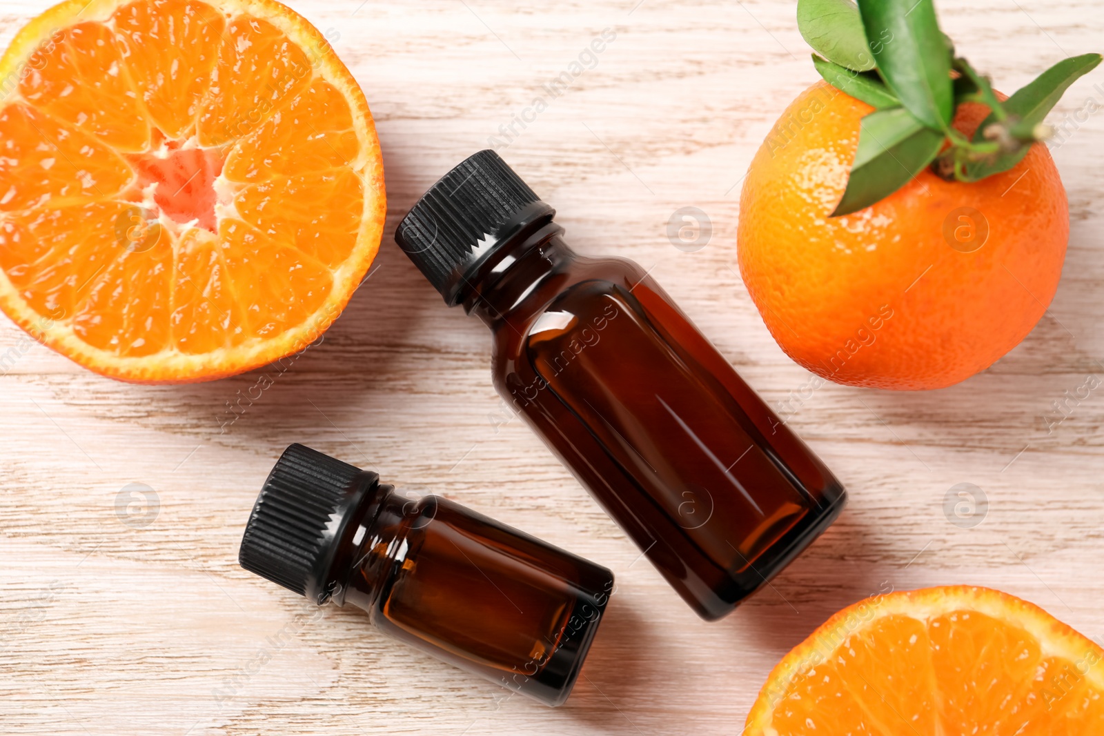 Photo of Flat lay composition with tangerine essential oil on wooden table