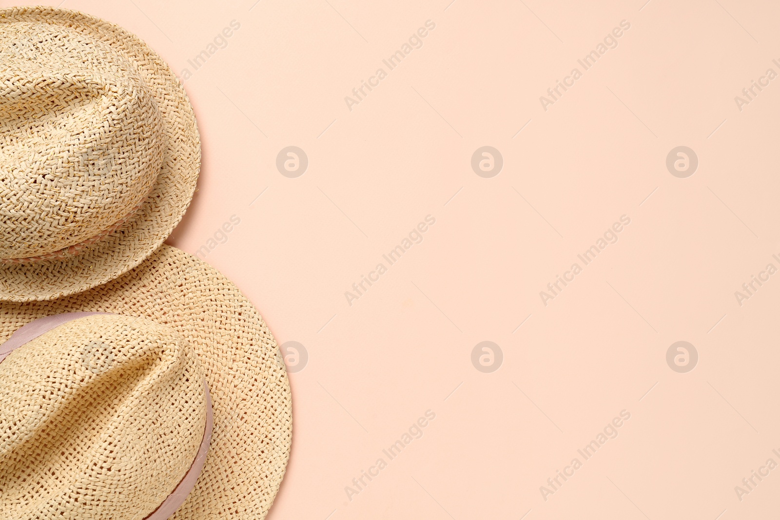 Photo of Stylish straw hats on beige background, flat lay. Space for text