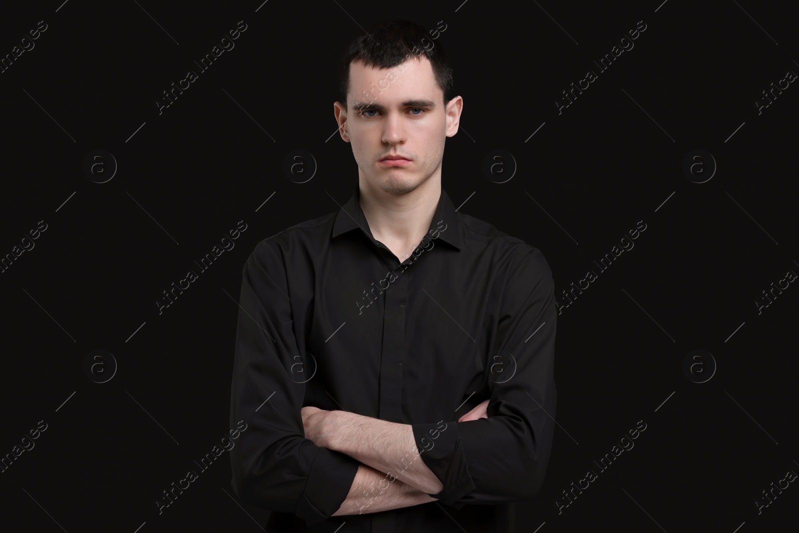 Photo of Portrait of sad man on black background