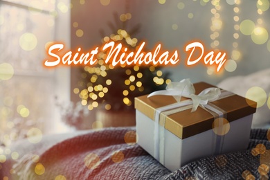 Saint Nicholas Day. Beautiful gift box on bed in room