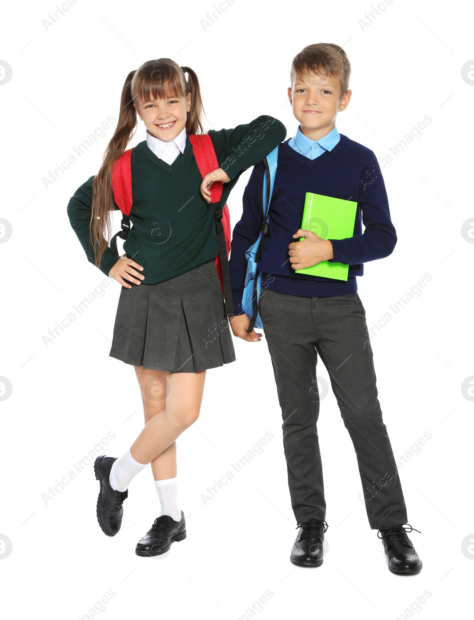 Photo of Little children in stylish school uniform on white background