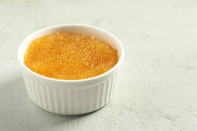Photo of Fresh pike caviar in bowl on light grey table, closeup. Space for text